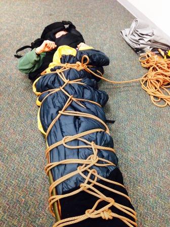 Alys strapped into a rope litter during WFR class